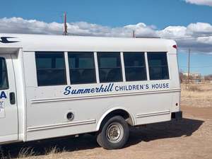 White 1990 GMC Shuttle Bus